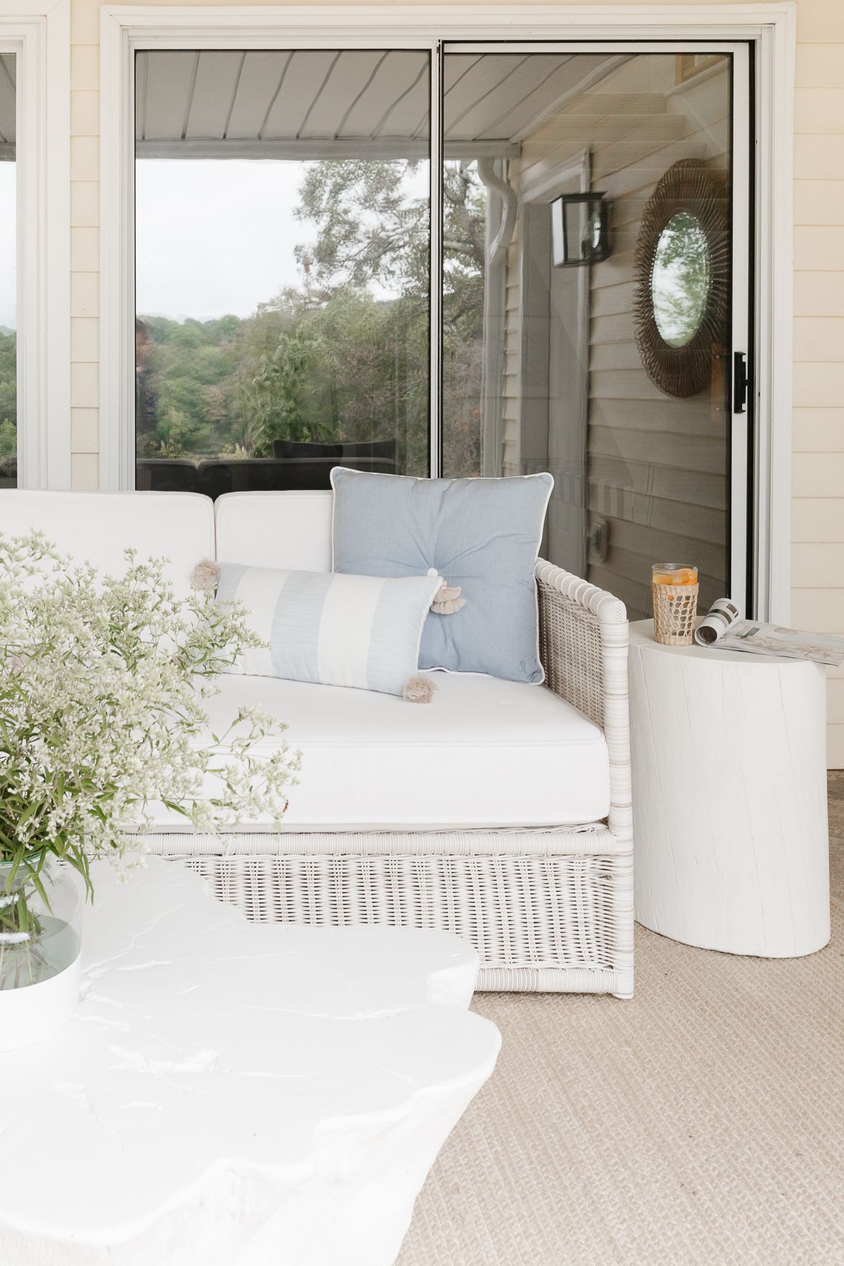 a white wicker rattan sofa on a patio