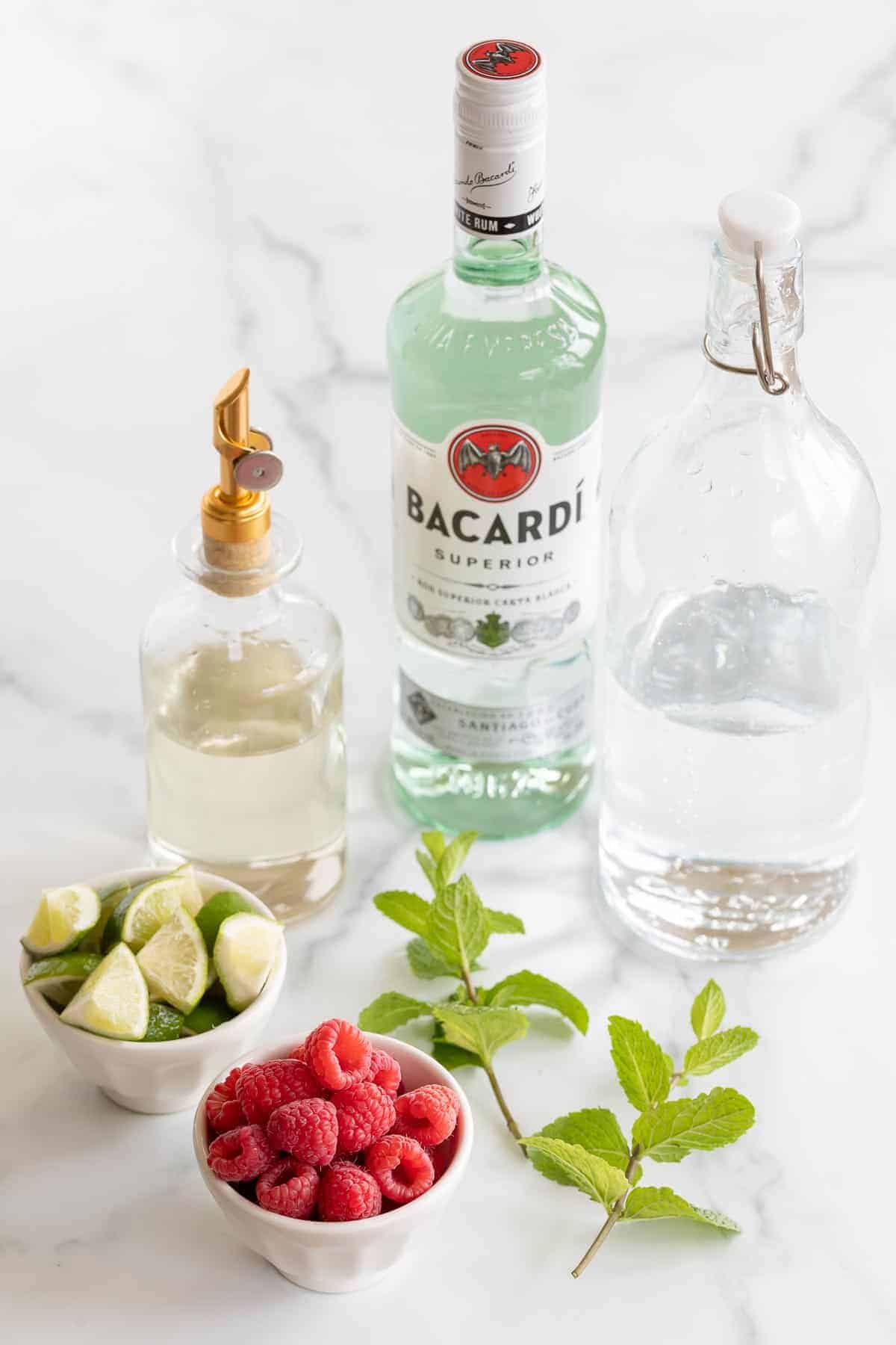 raspberry mojito ingredients displayed on marble surface