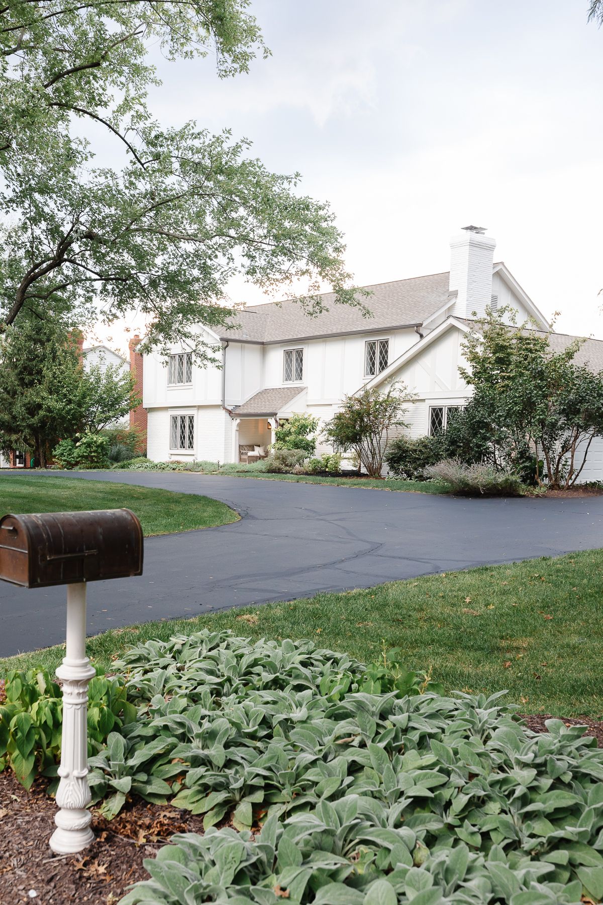 A vintage 70s tudor home, with soft cream and greige tudor paint colors.