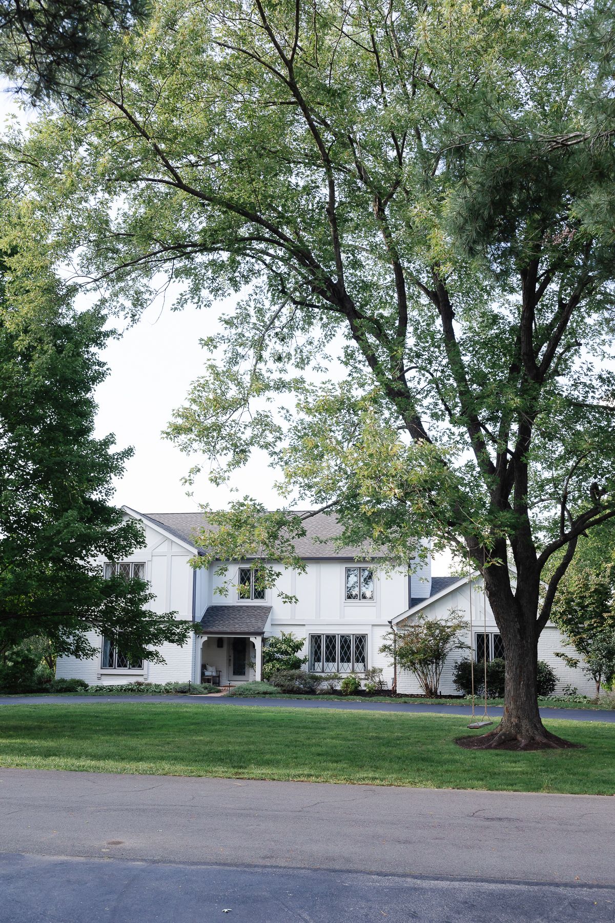 A vintage 70s tudor home, with soft cream and greige tudor paint colors.