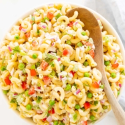 A white bowl full of macaroni salad.