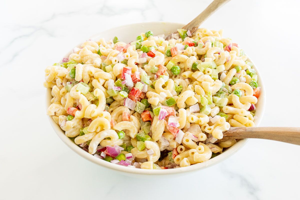 A white bowl full of macaroni salad.