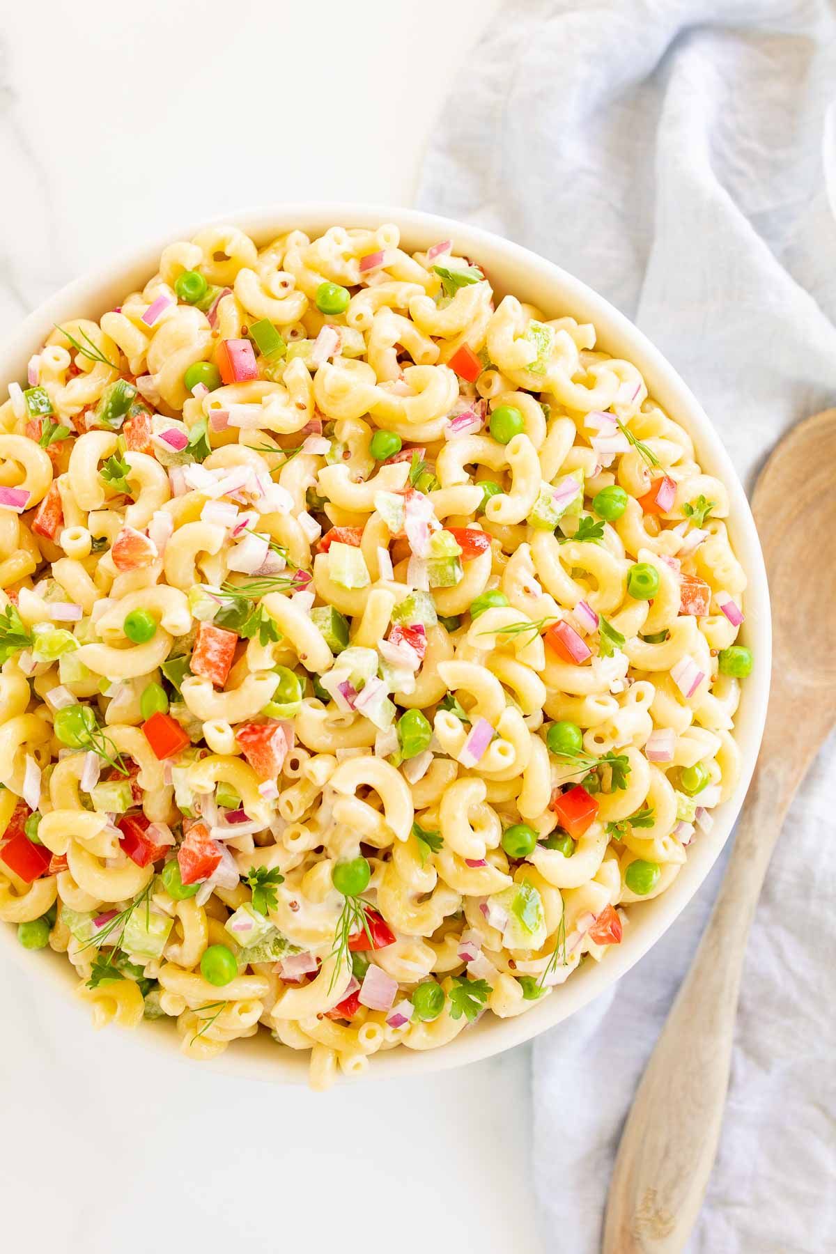 A white bowl full of macaroni salad.