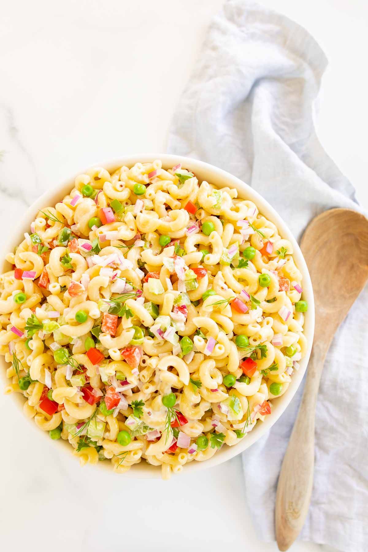 A white bowl full of macaroni salad.