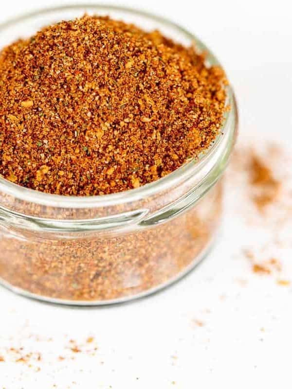 A clear glass jar filled with homemade elote seasoning.