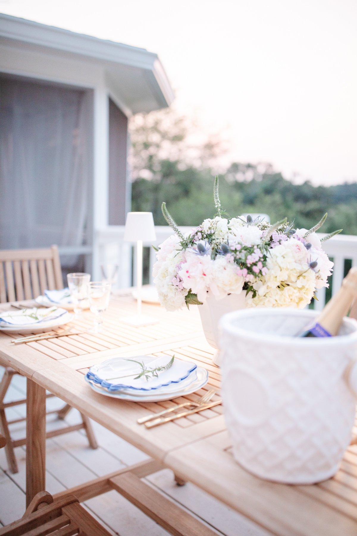 An outdoor dining table set for dinner in a guide to luxury home decor for less