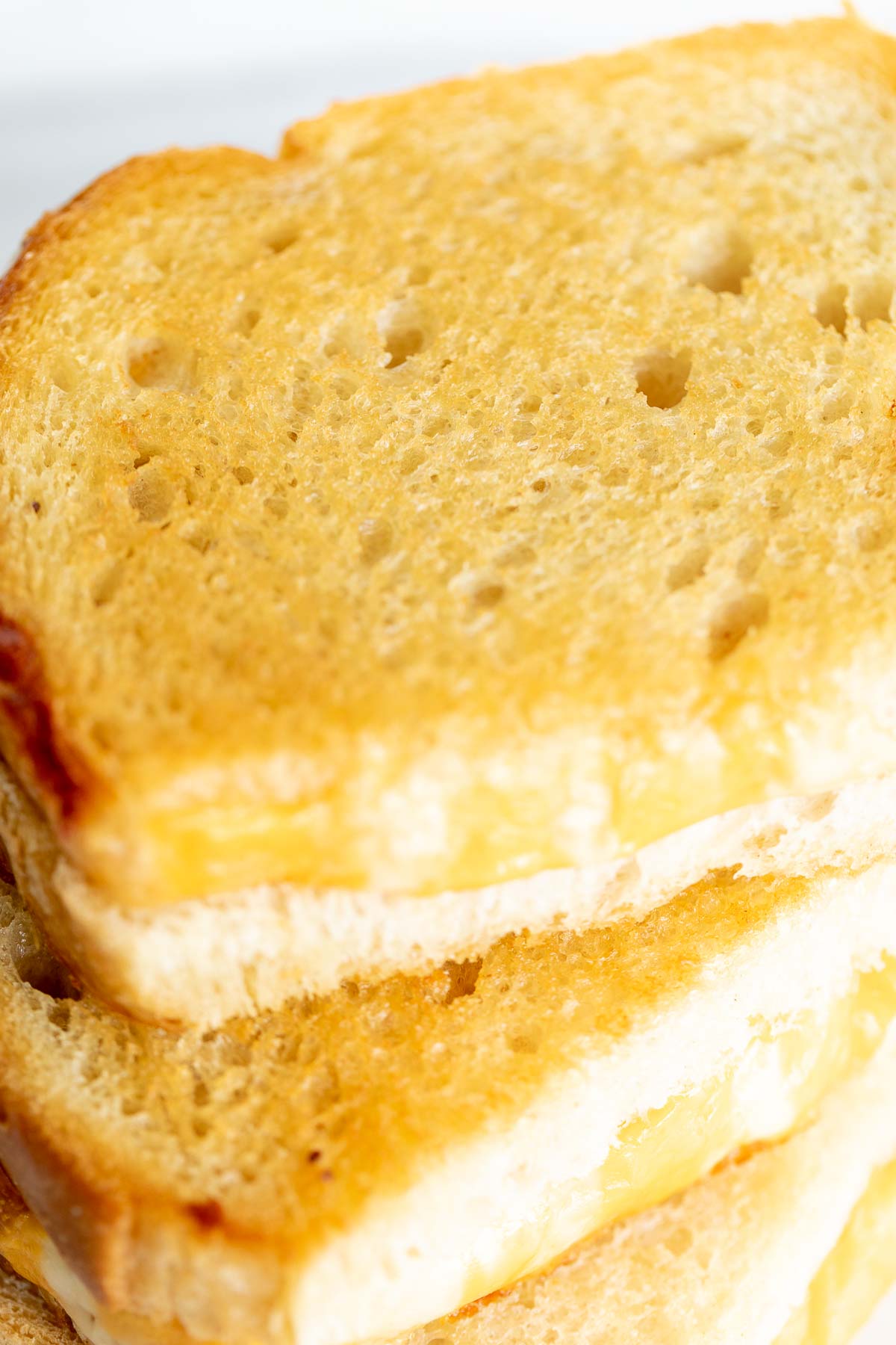 An oven baked grilled cheese on a marble countertop.