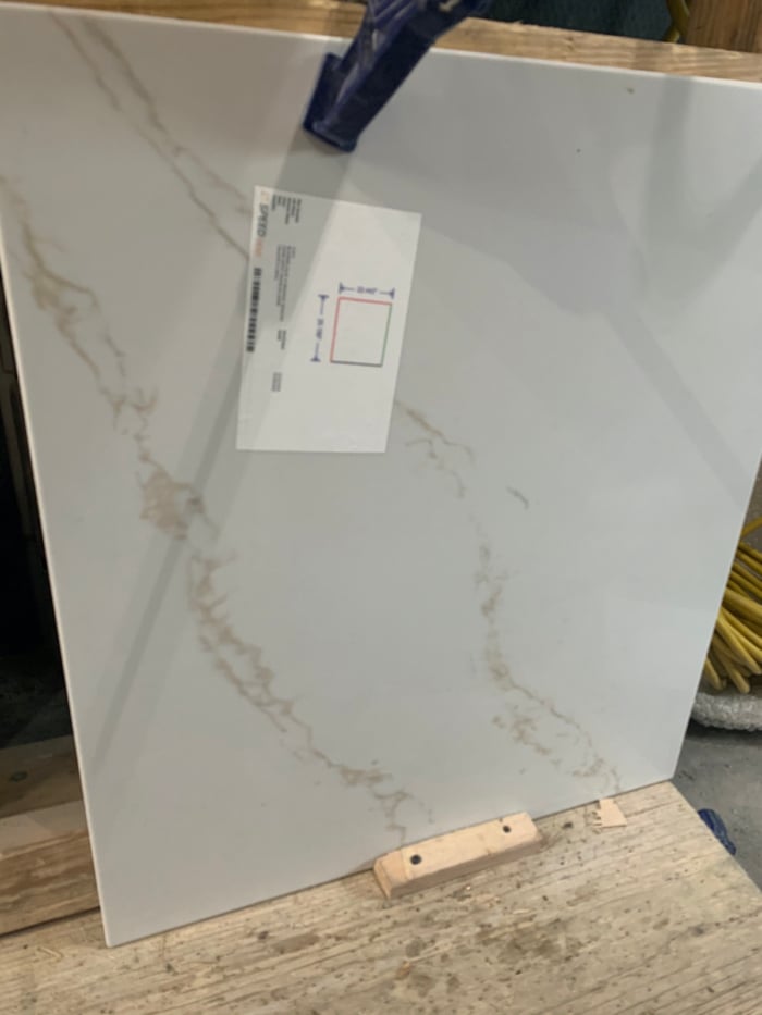 A white quartz countertop slab in a warehouse.