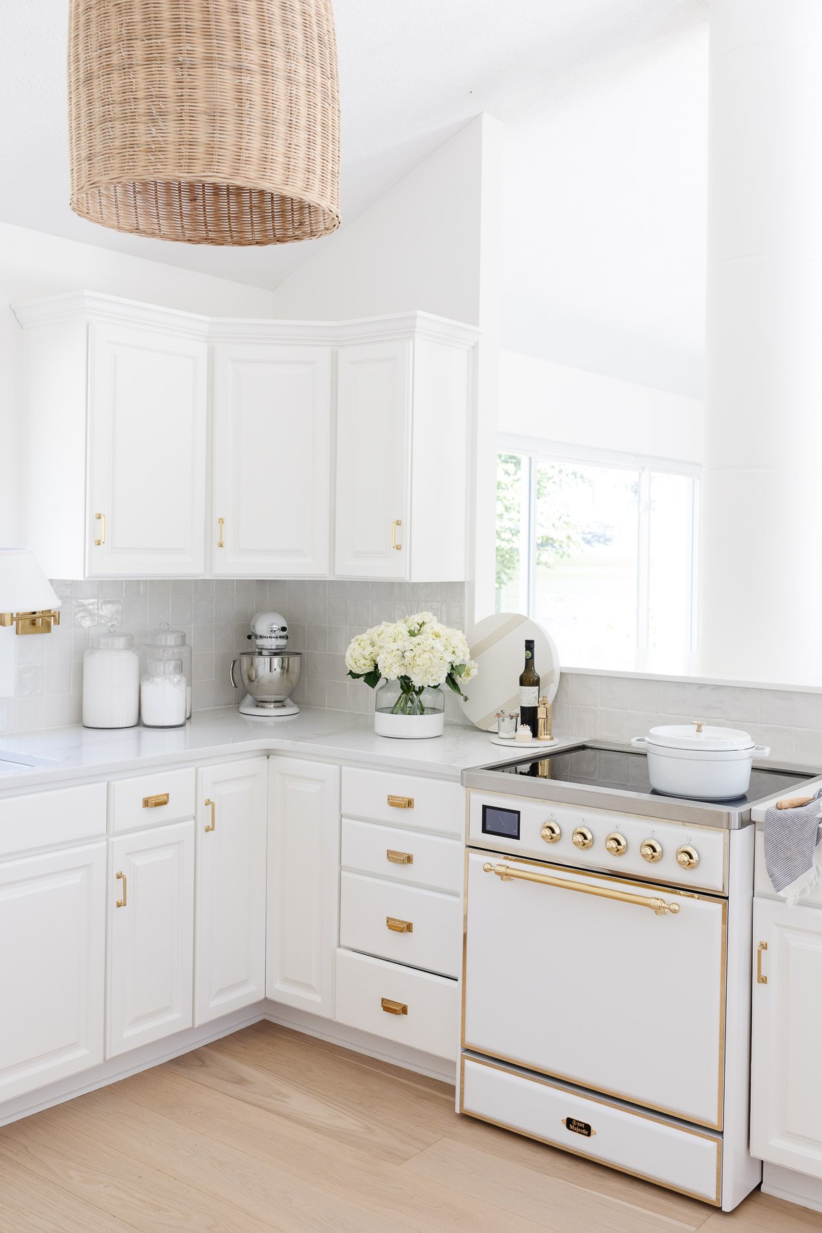 A white kitchen featuring white quartz countertops.