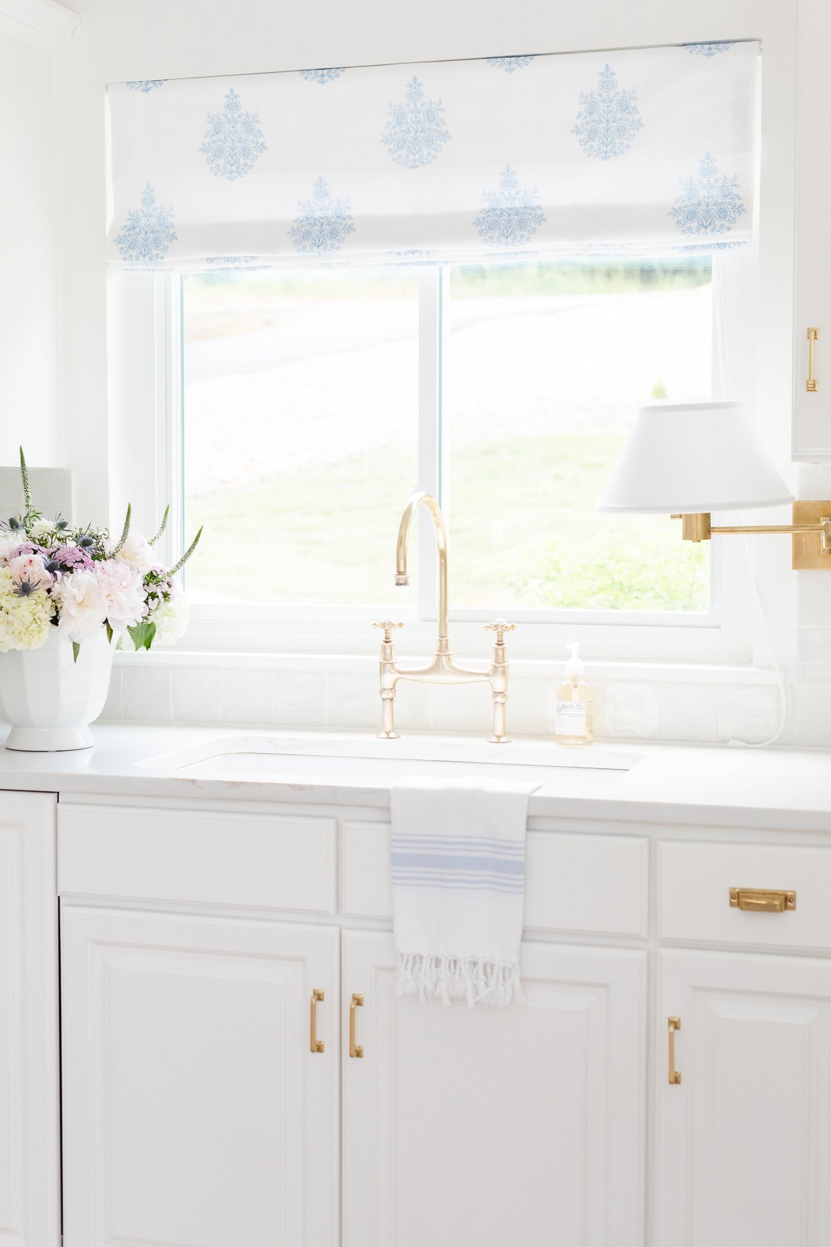 A white kitchen featuring white quartz countertops.