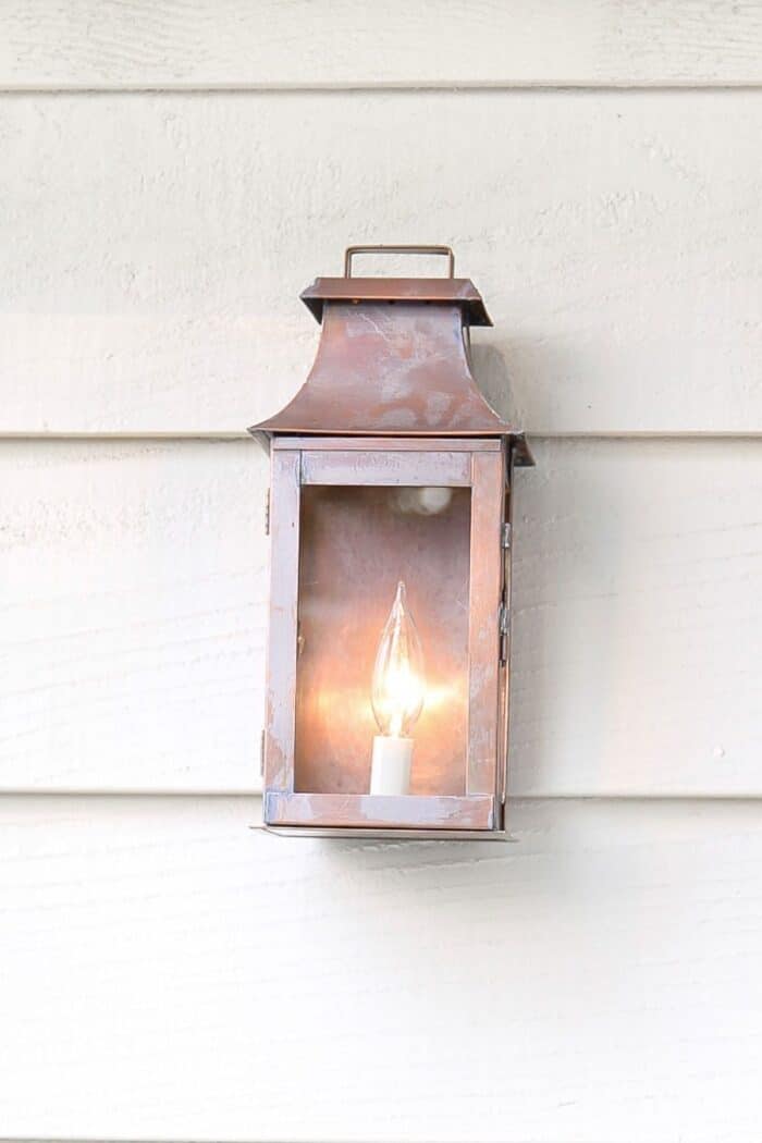 Exterior copper lanterns on a cream painted home.