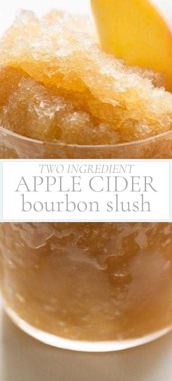 Glass of icy apple cider bourbon slush garnished with a slice of orange.