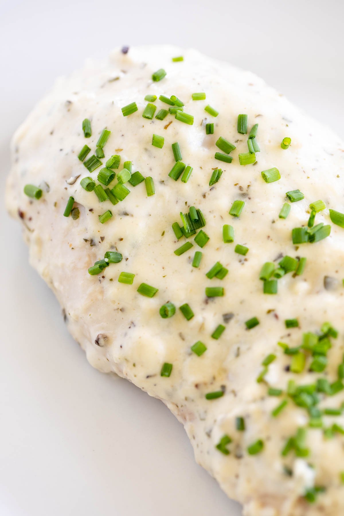 Boursin chicken topped with chopped chives.