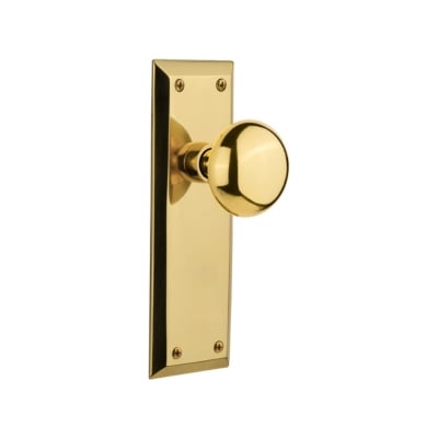 an unlacquered brass door knob on a white background