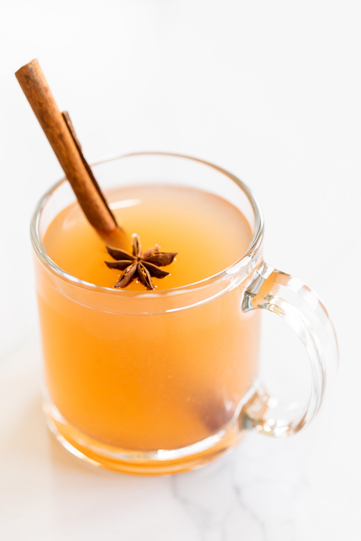 a clear glass mug of homemade pear cider