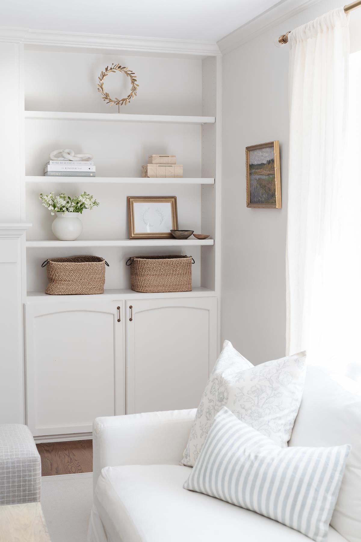 Built in bookshelves styled with neutral decor and home accessories.