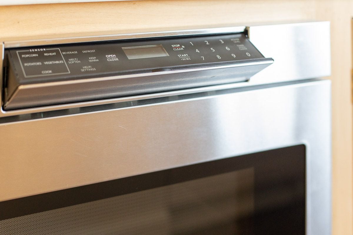 A stainless steel microwave drawer set into a kitchen island