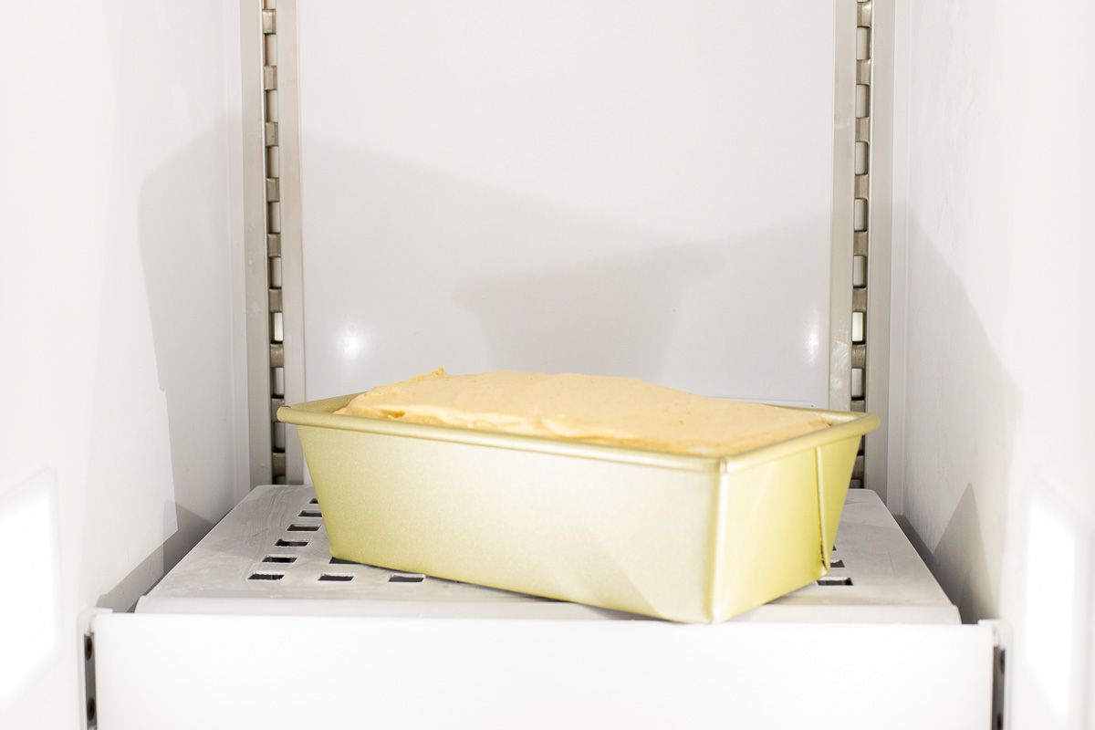 A loaf pan full of no churn ice cream inside a freezer.