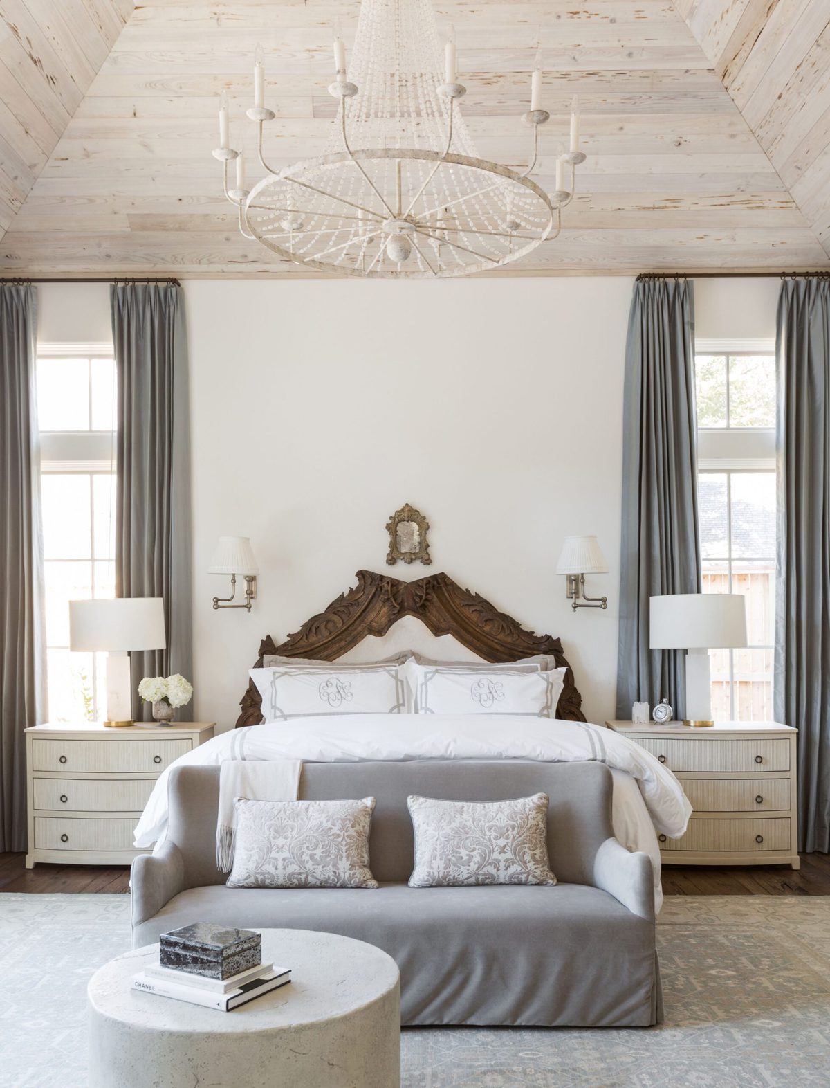 A European inspired bedroom with walls painted Cloud White from Benjamin Moore