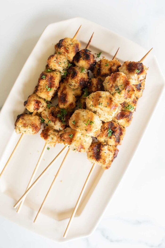 Chicken spiedini skewers on a white platter