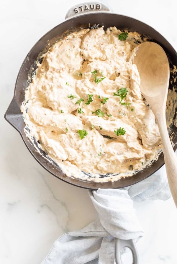 A cast iron skillet filled with cream cheese chicken