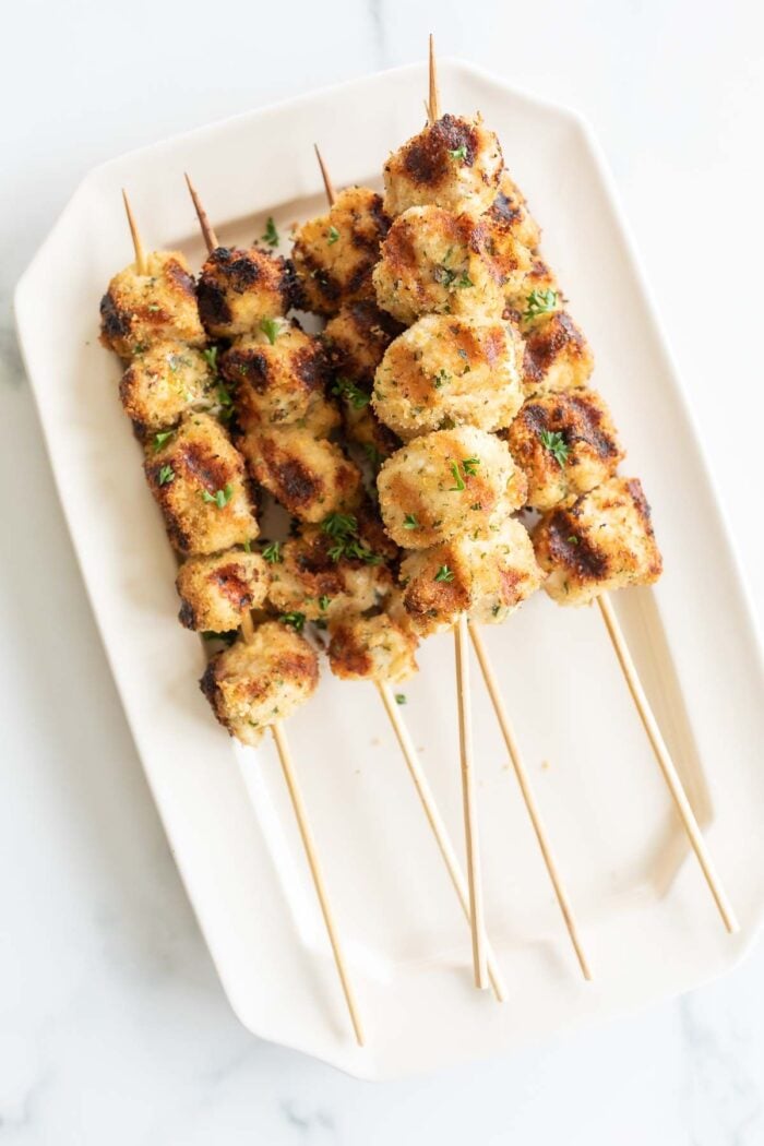 Chicken spiedini skewers on a white platter