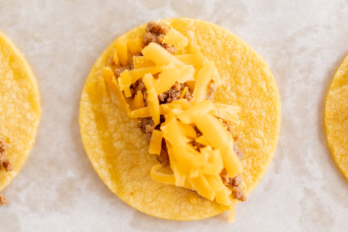 mini tacos on a parchment lined baking sheet.