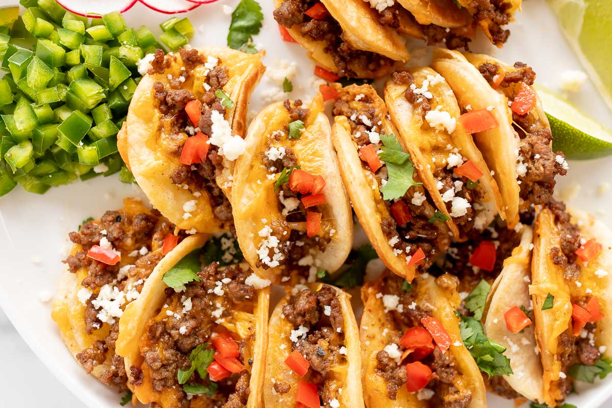 Beef mini tacos on a white platter.