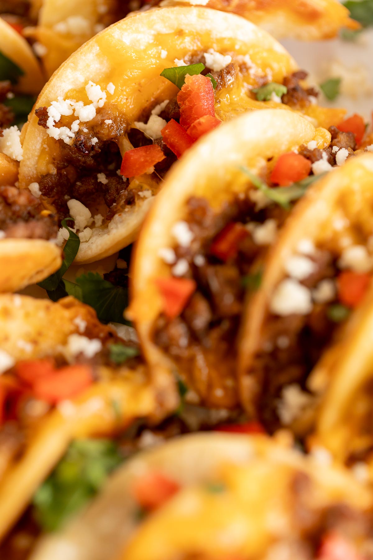 Beef mini tacos on a white platter.