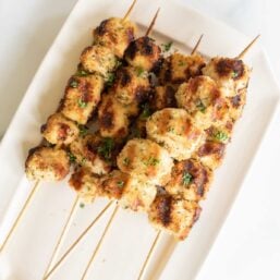 Chicken spiedini skewers on a white platter