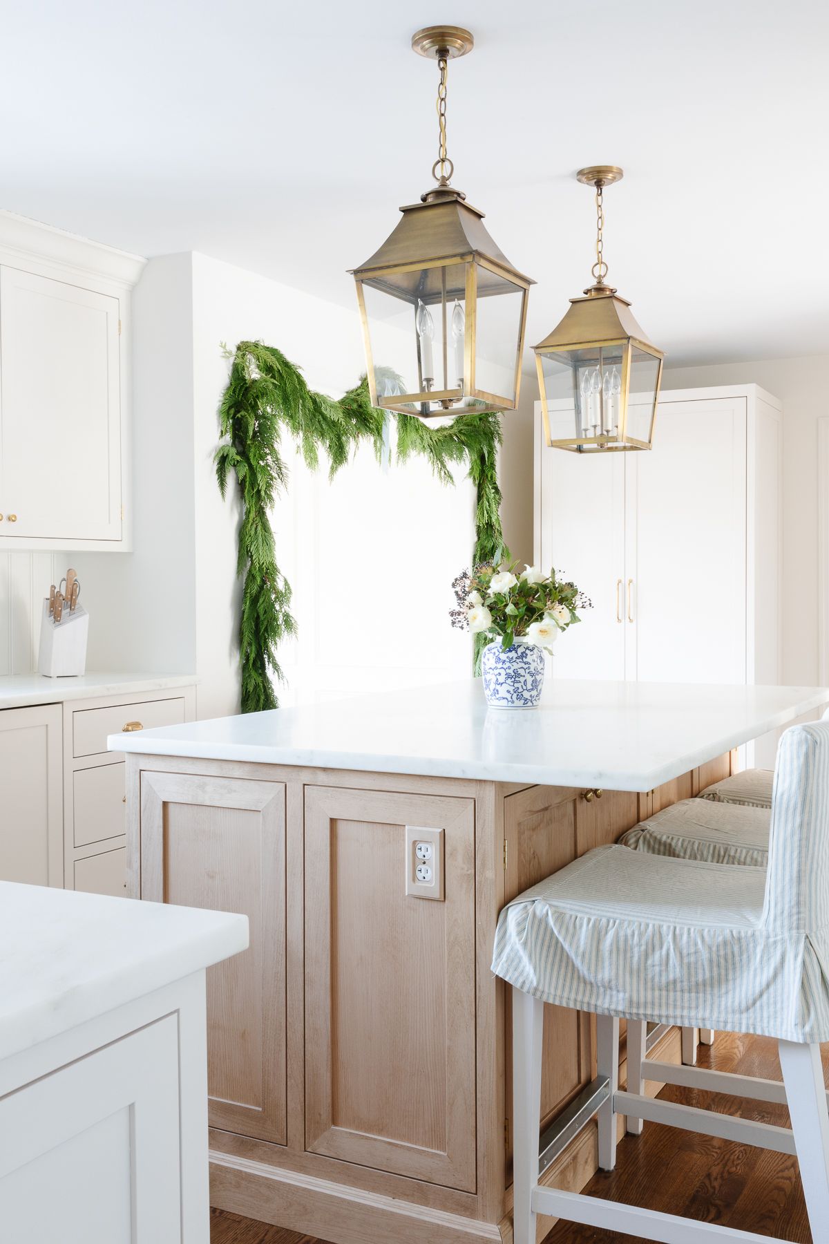 Fresh cedar garland on a kitchen door, tied with blue ribbon