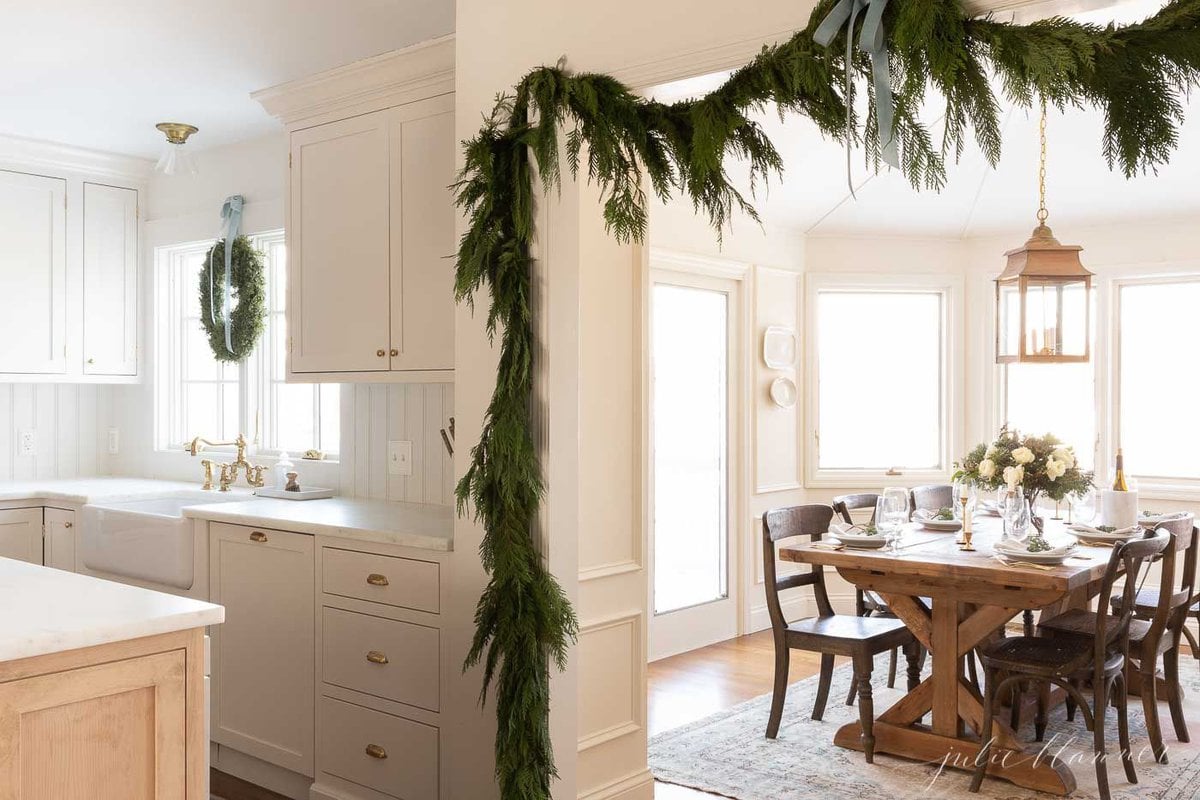 Fresh cedar garland on a kitchen door, tied with blue ribbon