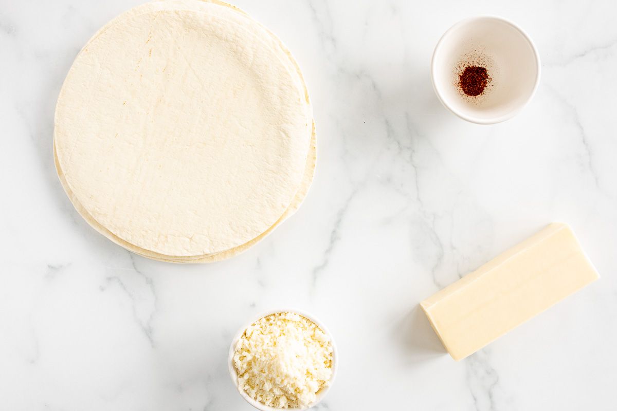 Quesadilla ingredients laid out on a marble surface