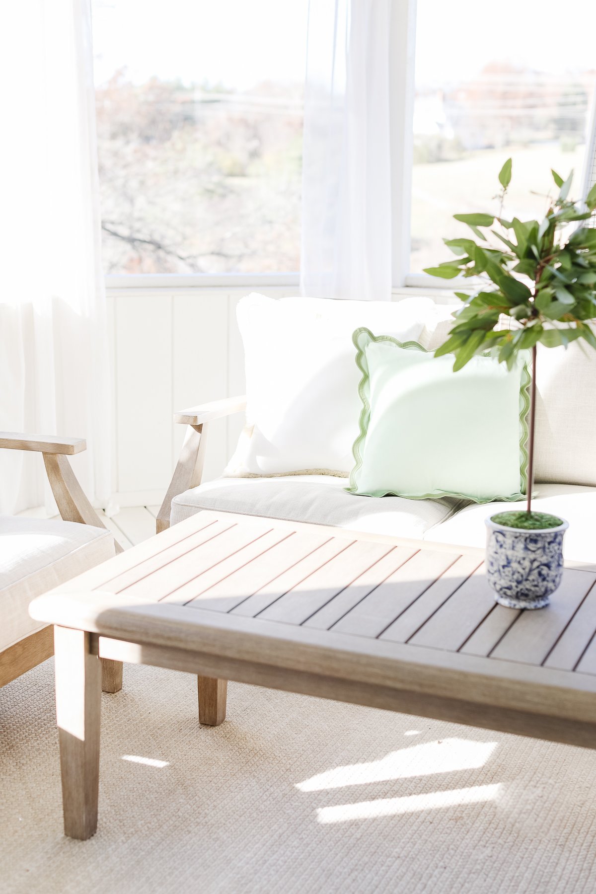 A white couch with neutral rugs in a living room.