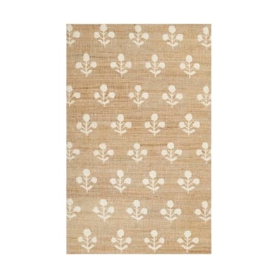 A neutral rug with white flowers on it.