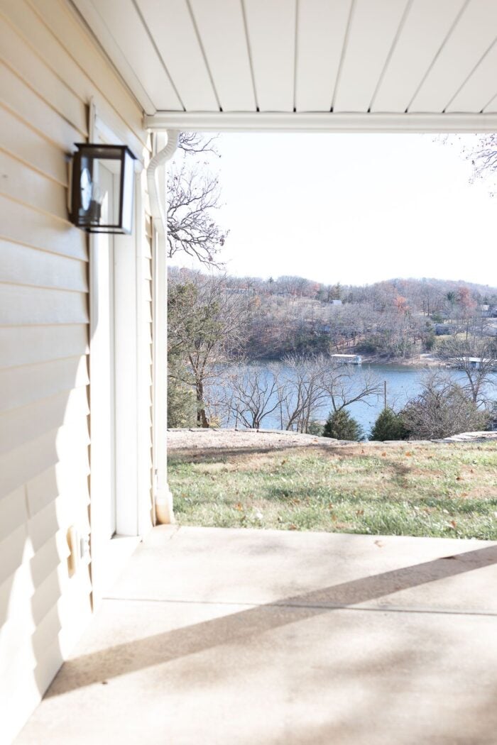 A concrete patio with a lake in the background