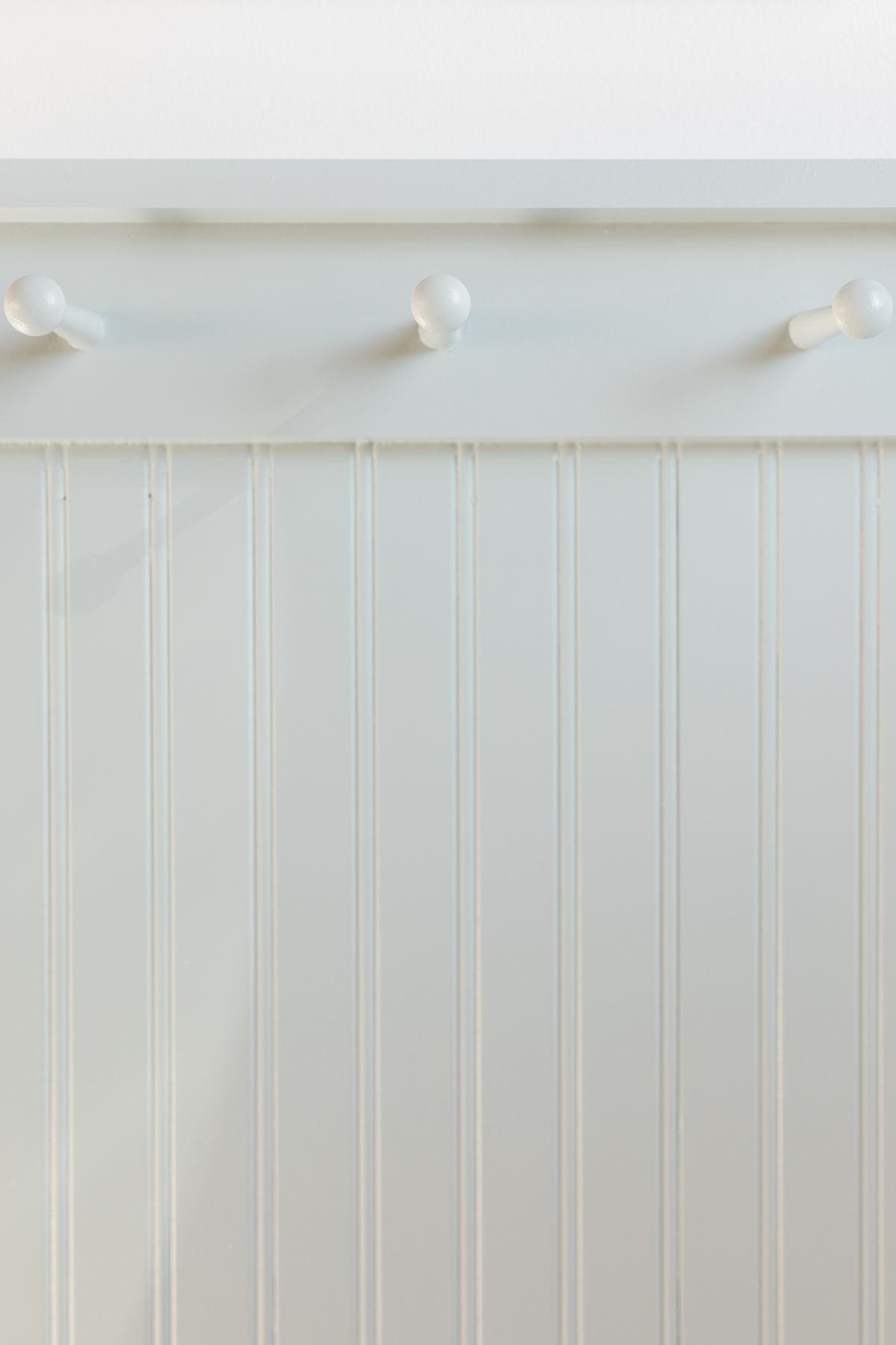 Beadboard trim with peg rail, painted in Benjamin Moore Smoke, Chantilly Lace walls above