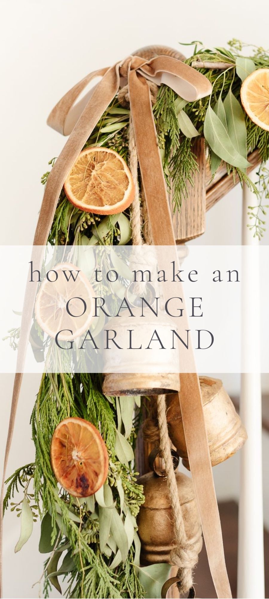 dried oranges and brass bells strung to a green garland, hung on a bannister