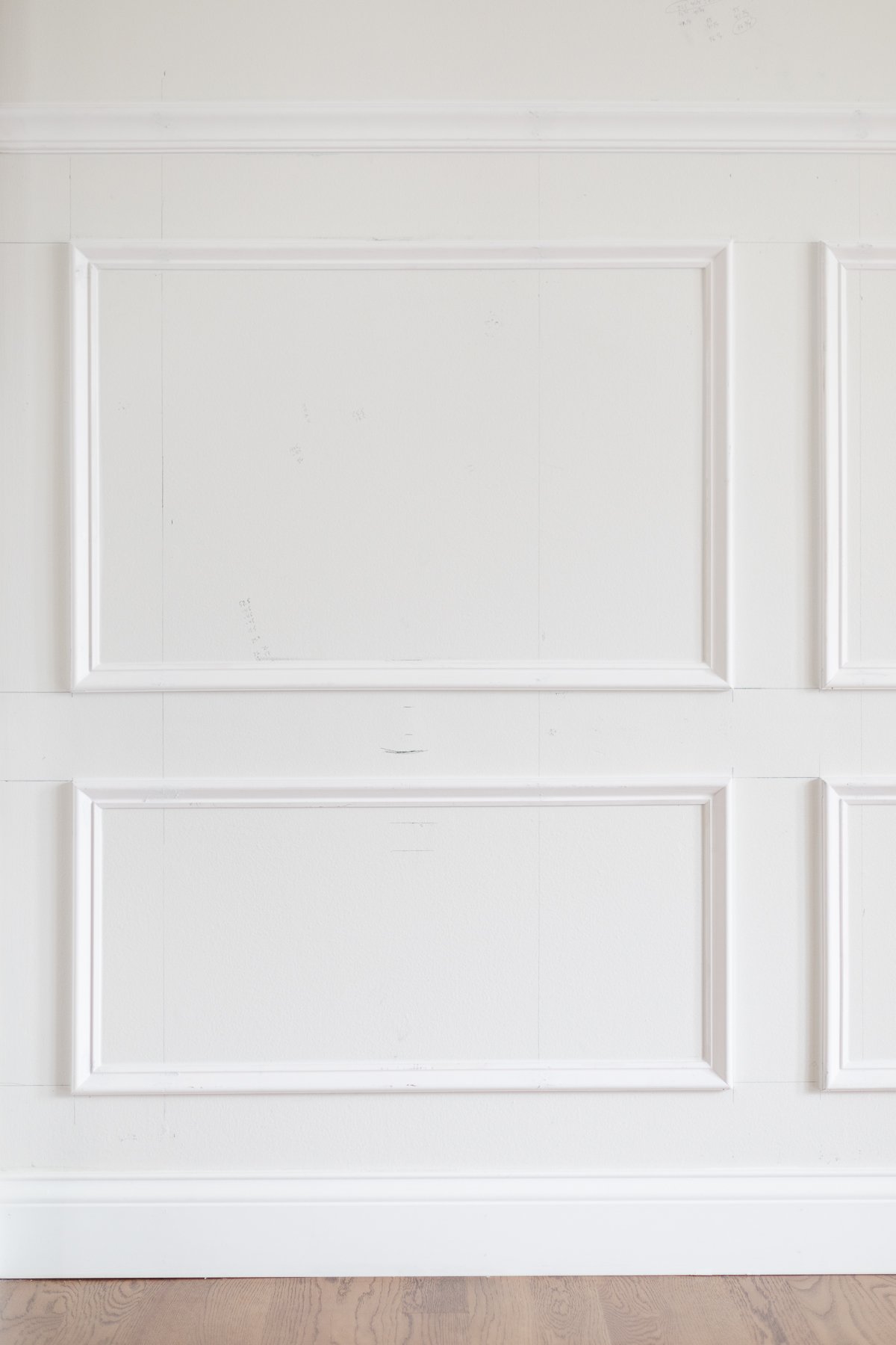 A dining room with window box molding, painted in Benjamin Moore Chantilly Lace.