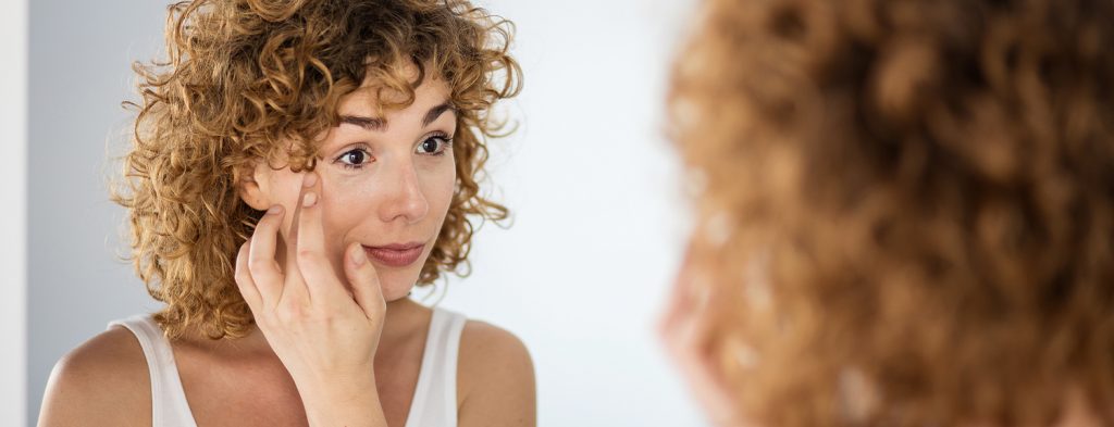 Woman applying eye creams