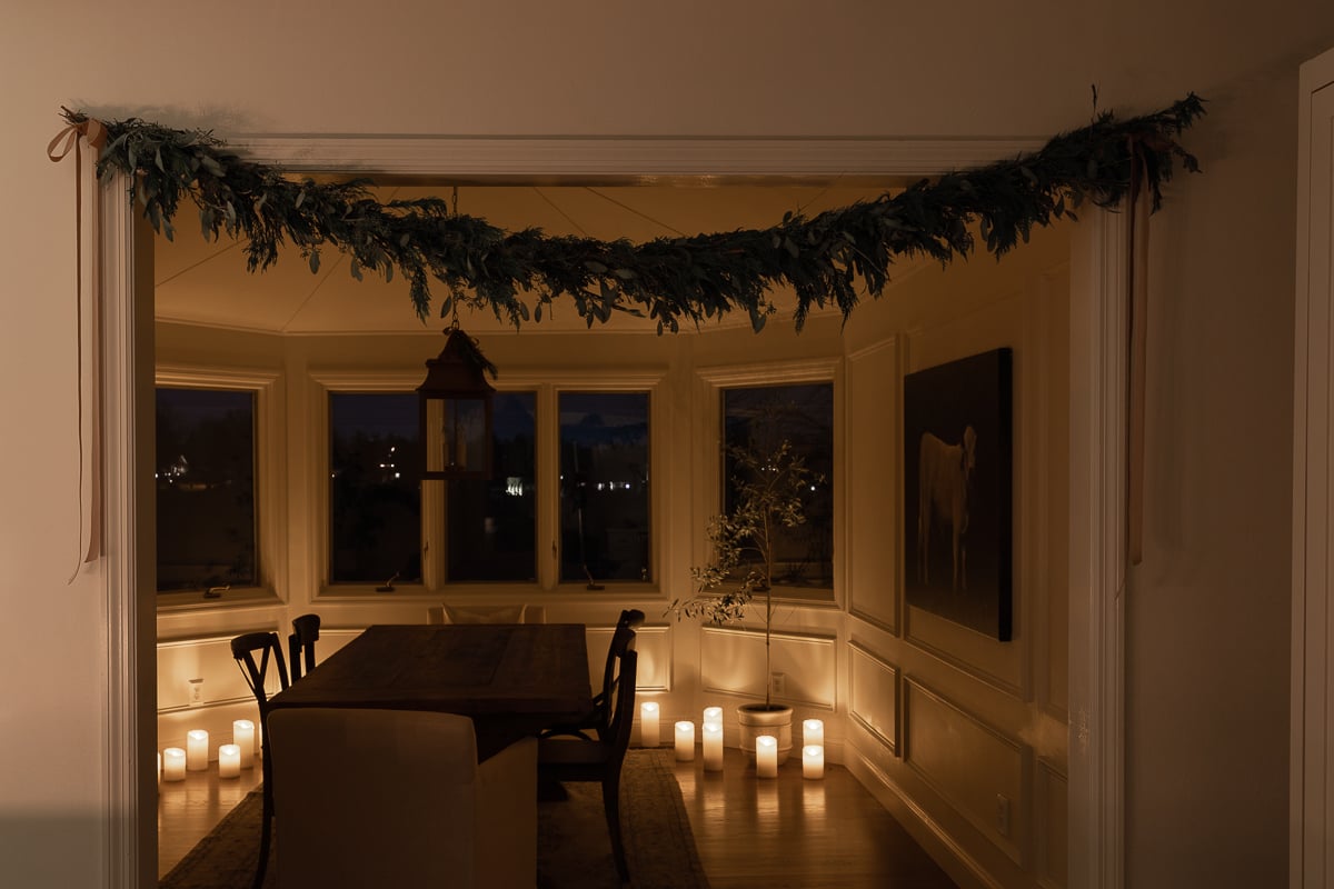 candle lit room with garland overhead