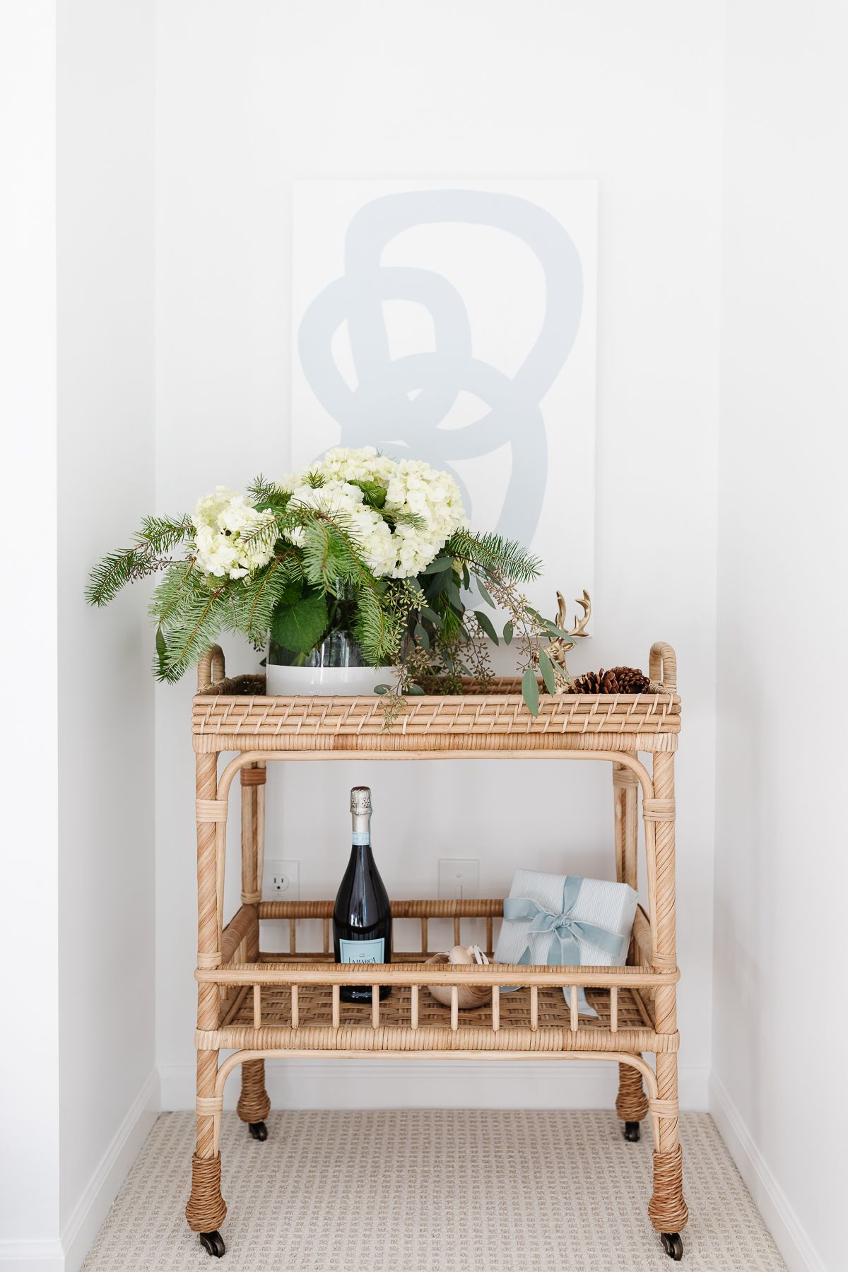 A rattan bar cart in the corner of a Chantilly White painted room