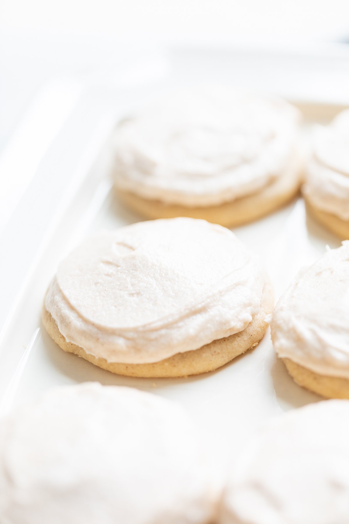 frosted cinnamon sugar cookies on a white platter