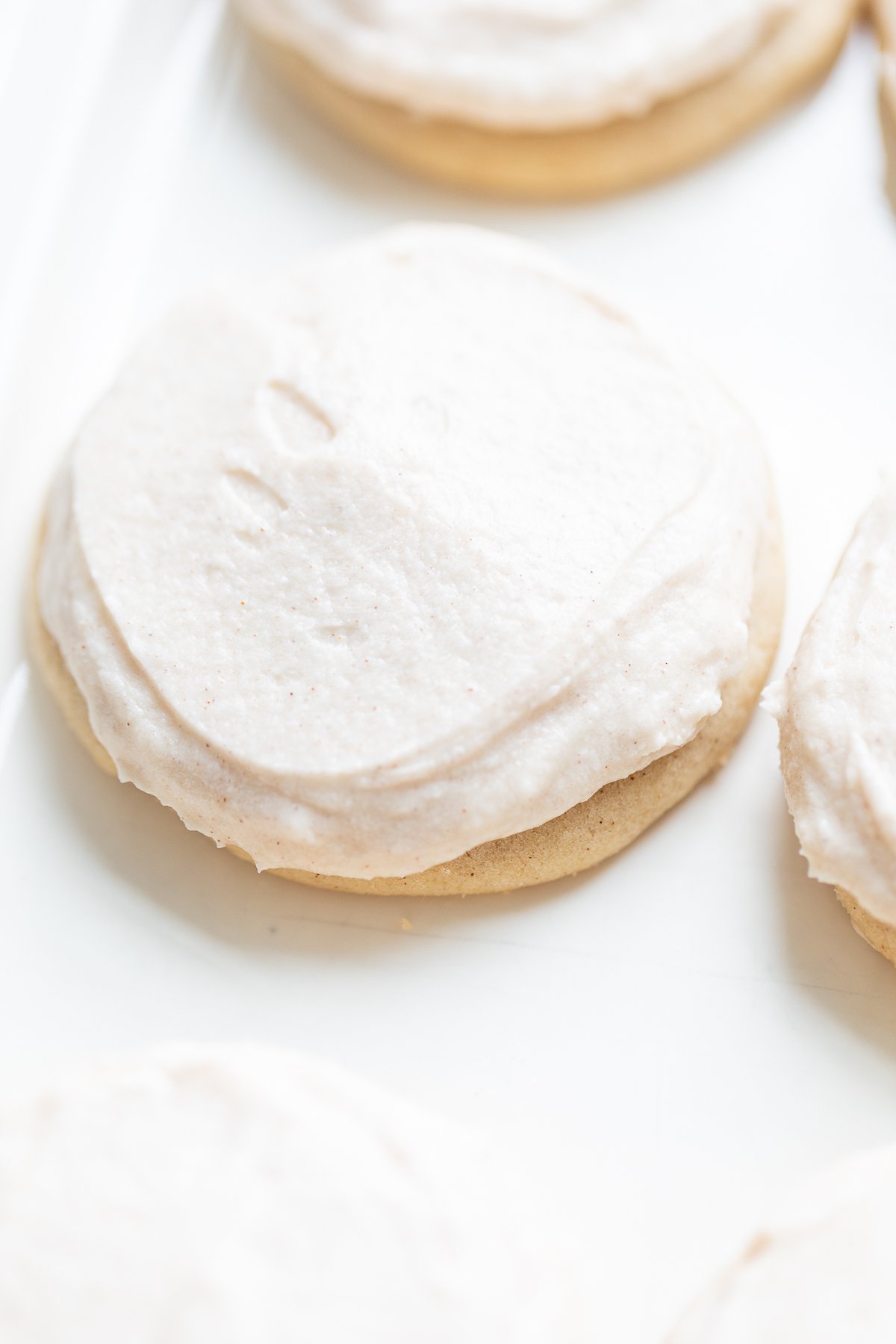 frosted cinnamon sugar cookies on a white platter