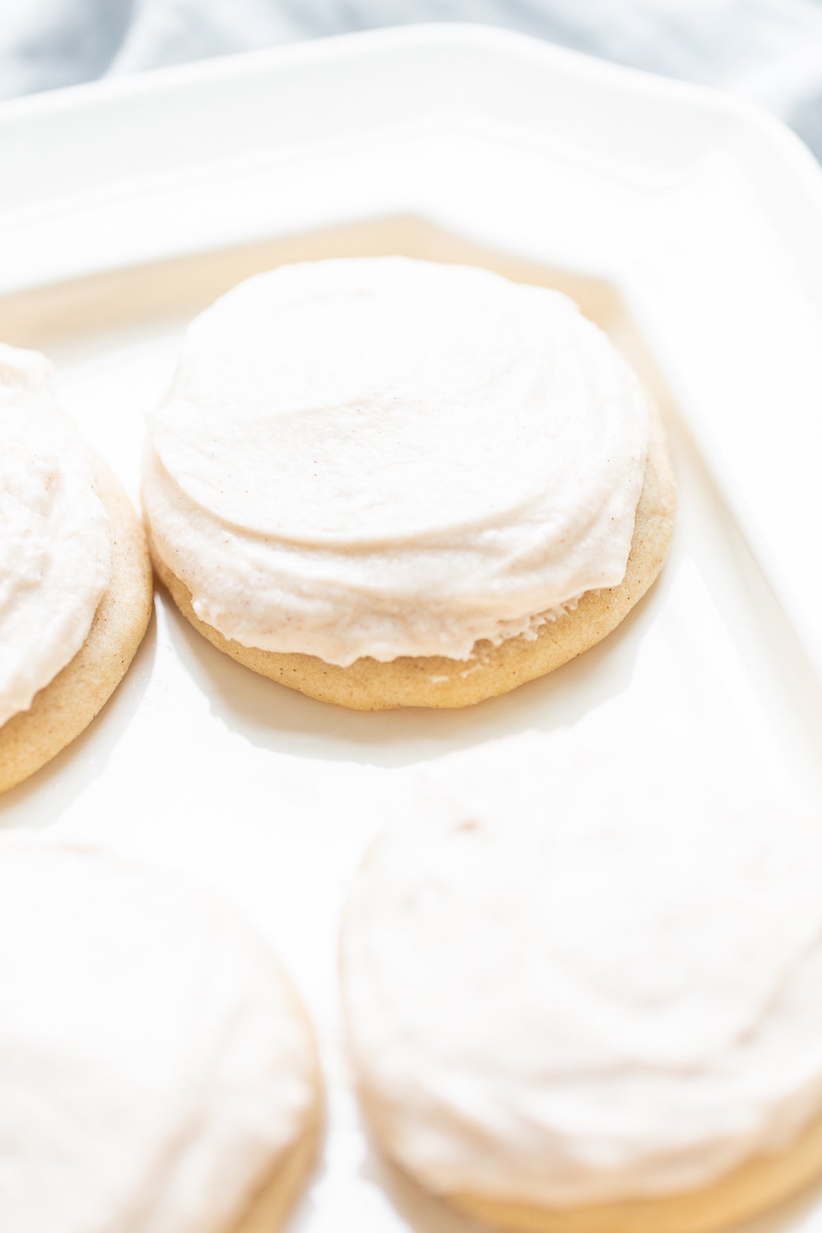 frosted cinnamon sugar cookies on a white platter