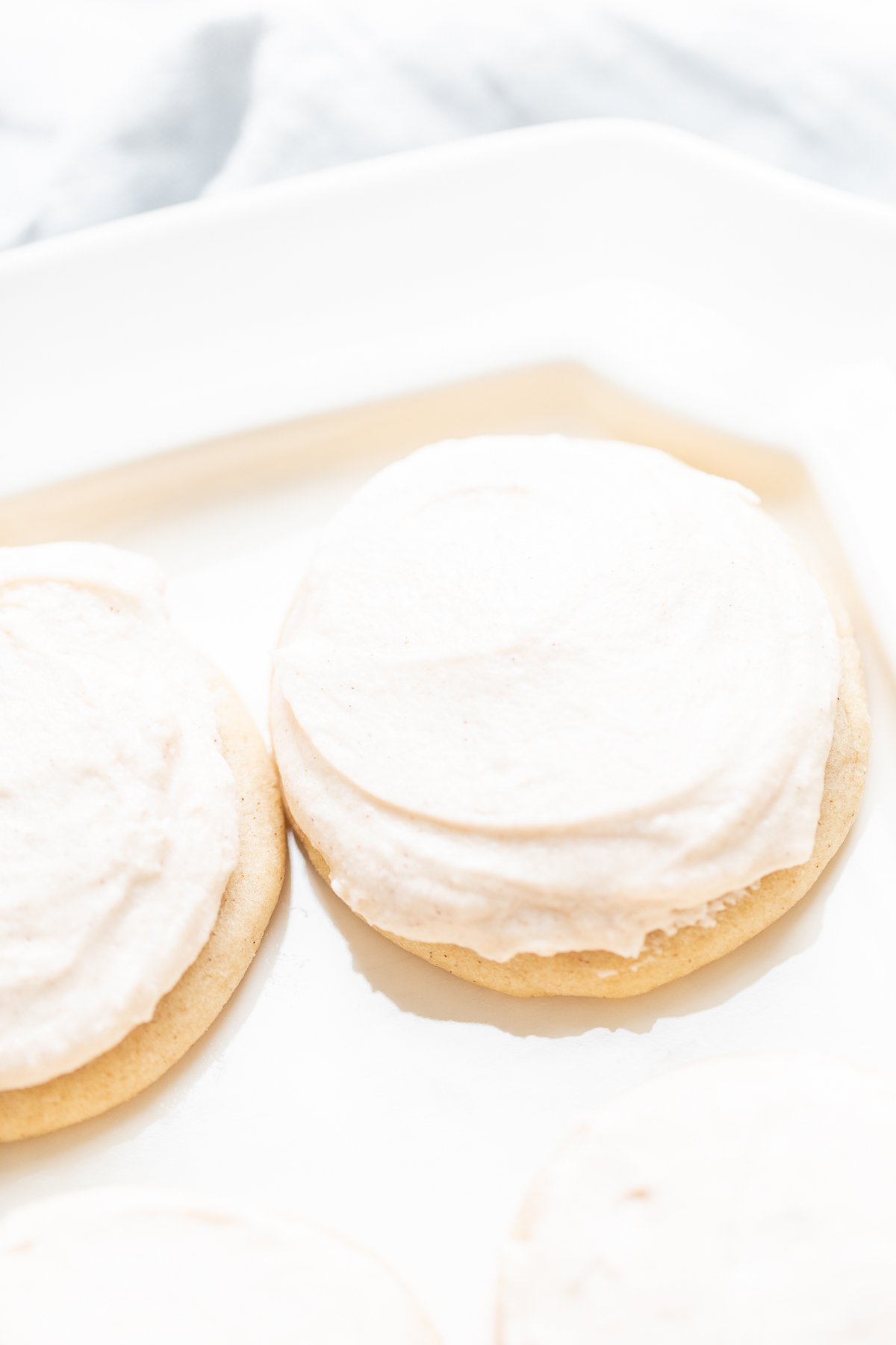 frosted cinnamon sugar cookies on a white platter