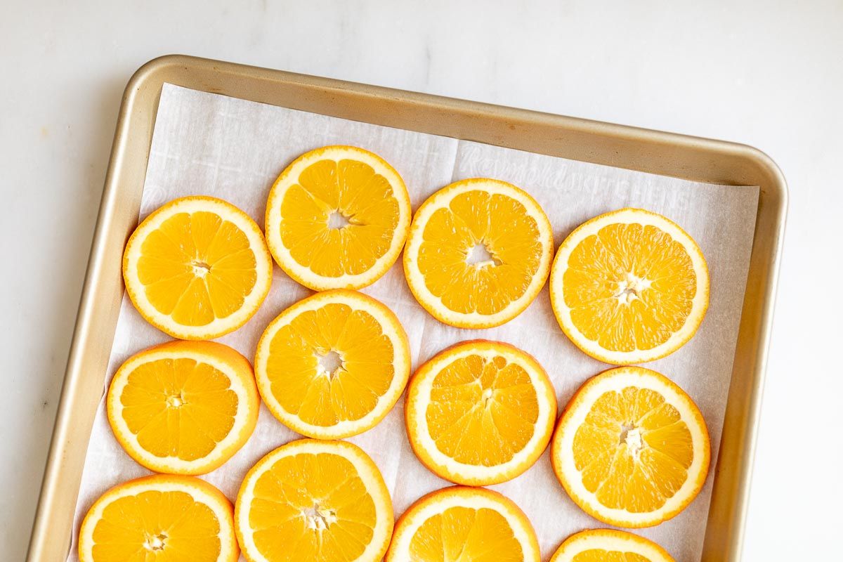 A baking sheet with sliced oranges