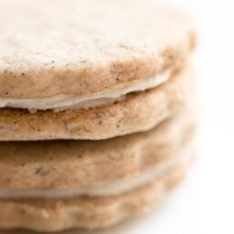 latte cookies with scalloped edge stacked on top of each other