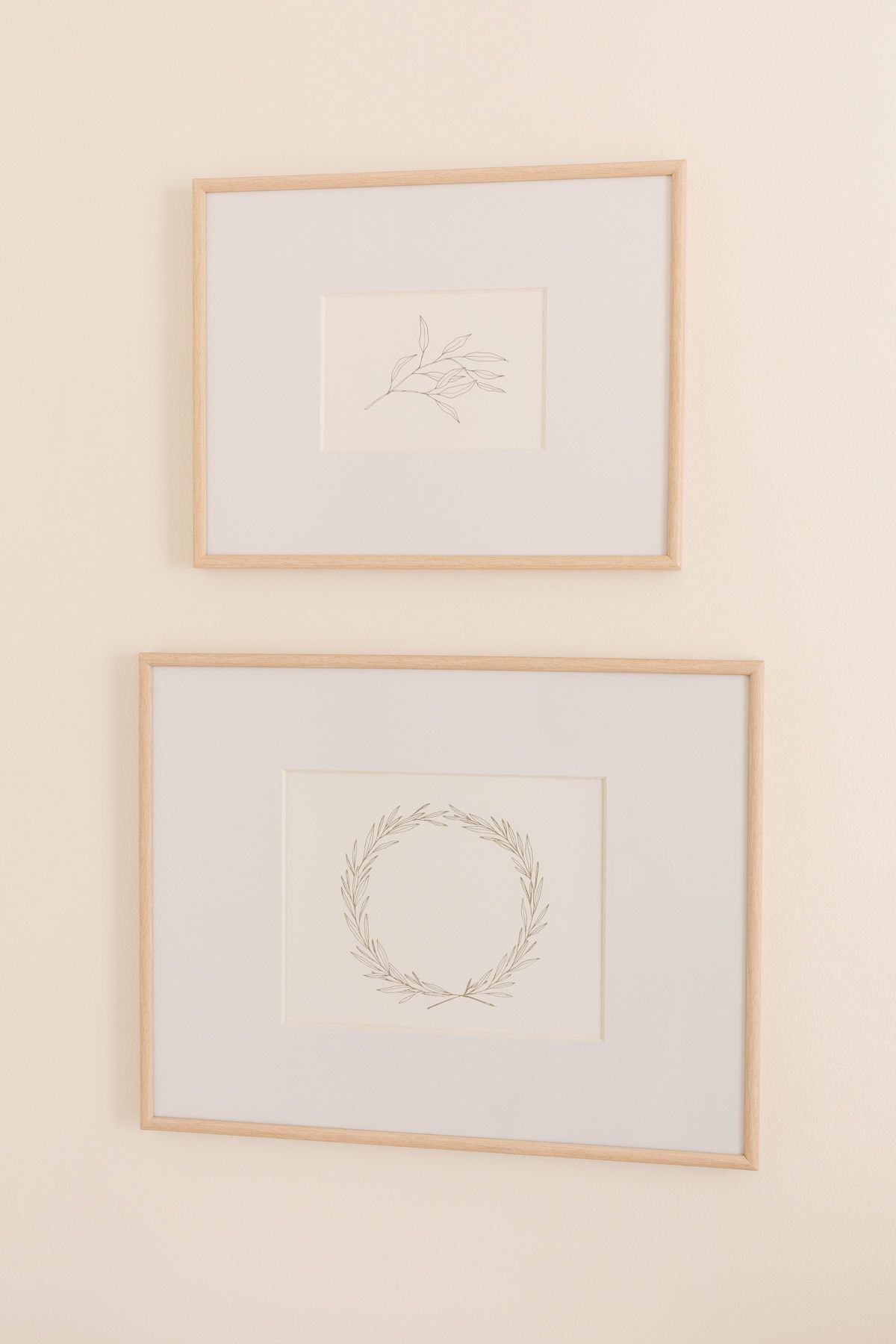 printable Christmas art in frames that are on a cream wall