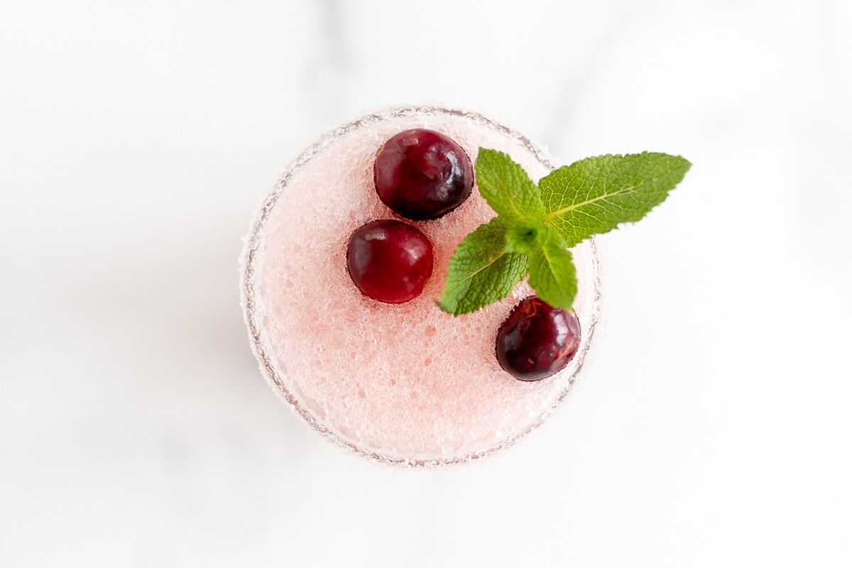 A marble surface with a glass full of a White Christmas margaritas